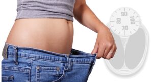 Bathroom scale showing the same number, representing a weight loss plateau and how to restart progress in 2026.